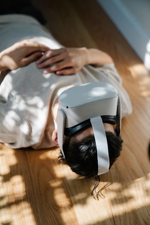 Free A Man Wearing a Virtual Reality Headset while Lying Down Stock Photo