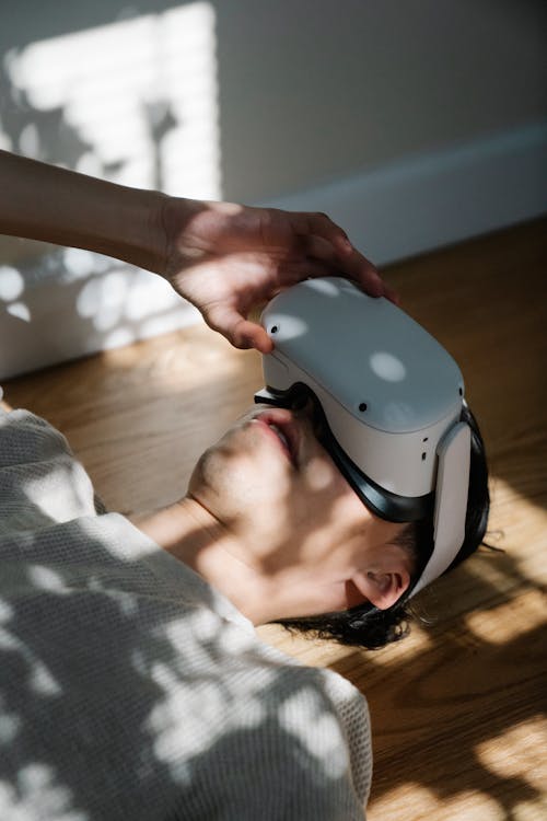 A Man Wearing a Virtual Reality Headset while Lying Down