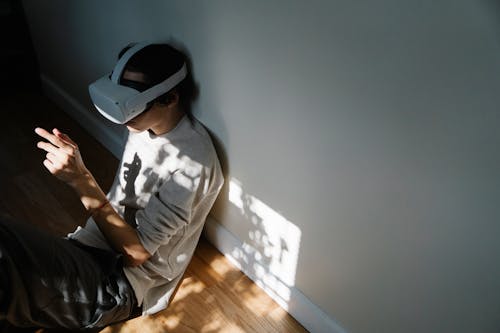 A Man Wearing a Virtual Reality Headset while Sitting on the Floor