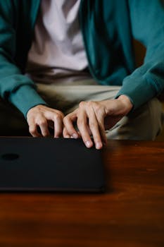 A man working on a laptop at home in a casual, comfortable setting. Perfect for freelance and remote work themes.