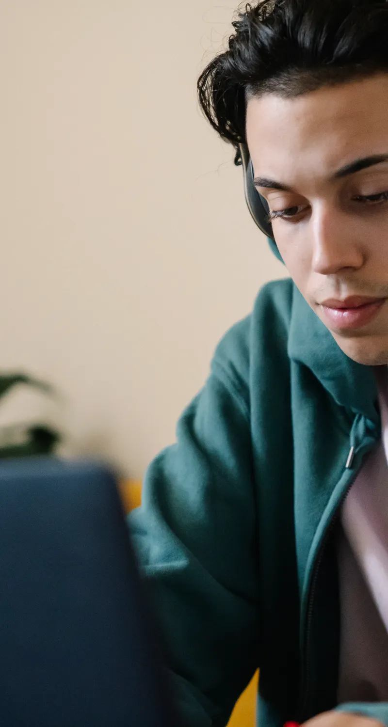 Student concentrating with headphones during DET Interactive Listening practice