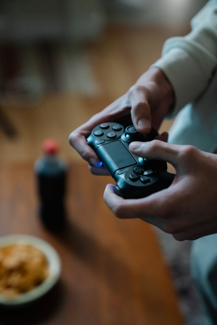 Crop Gamer With Joystick Playing Video Game In House