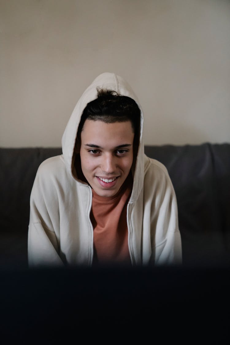 Smiling Ethnic Man On Sofa At Home