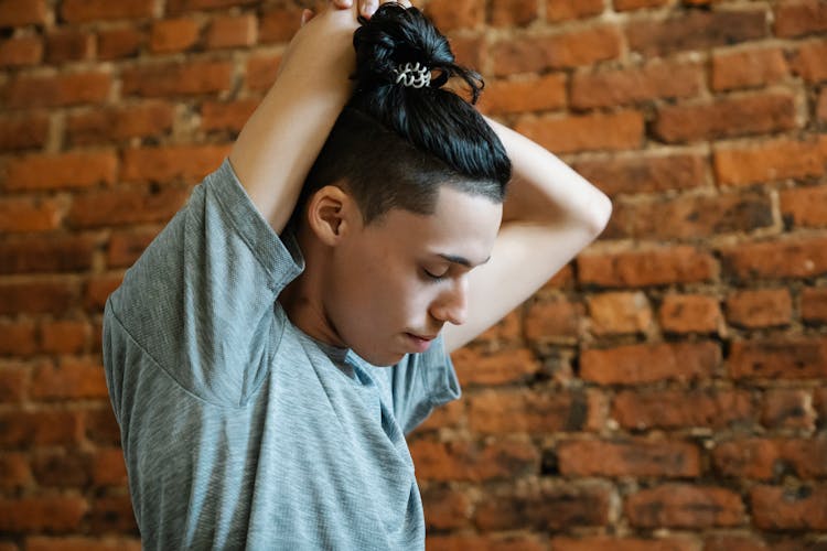 Teen Boy With Closed Eyes Putting Arms On Head