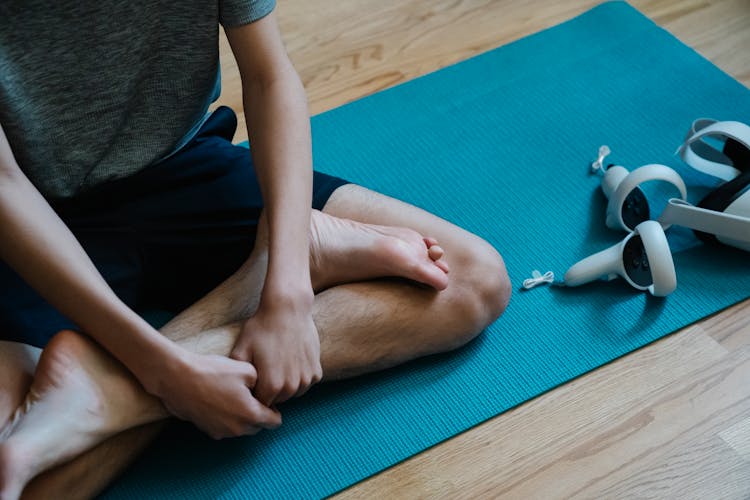 VR Headset Near Person In Lotus Pose