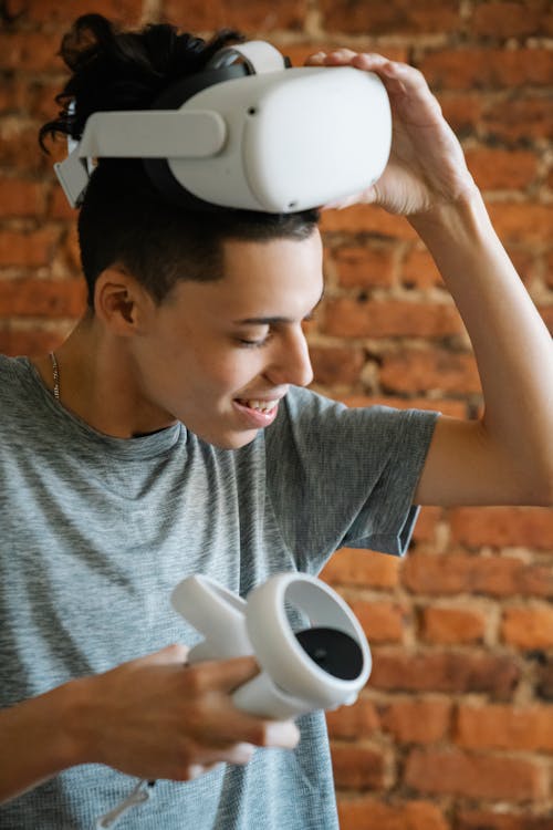 Young man taking off Oculus Quest 2 after playing