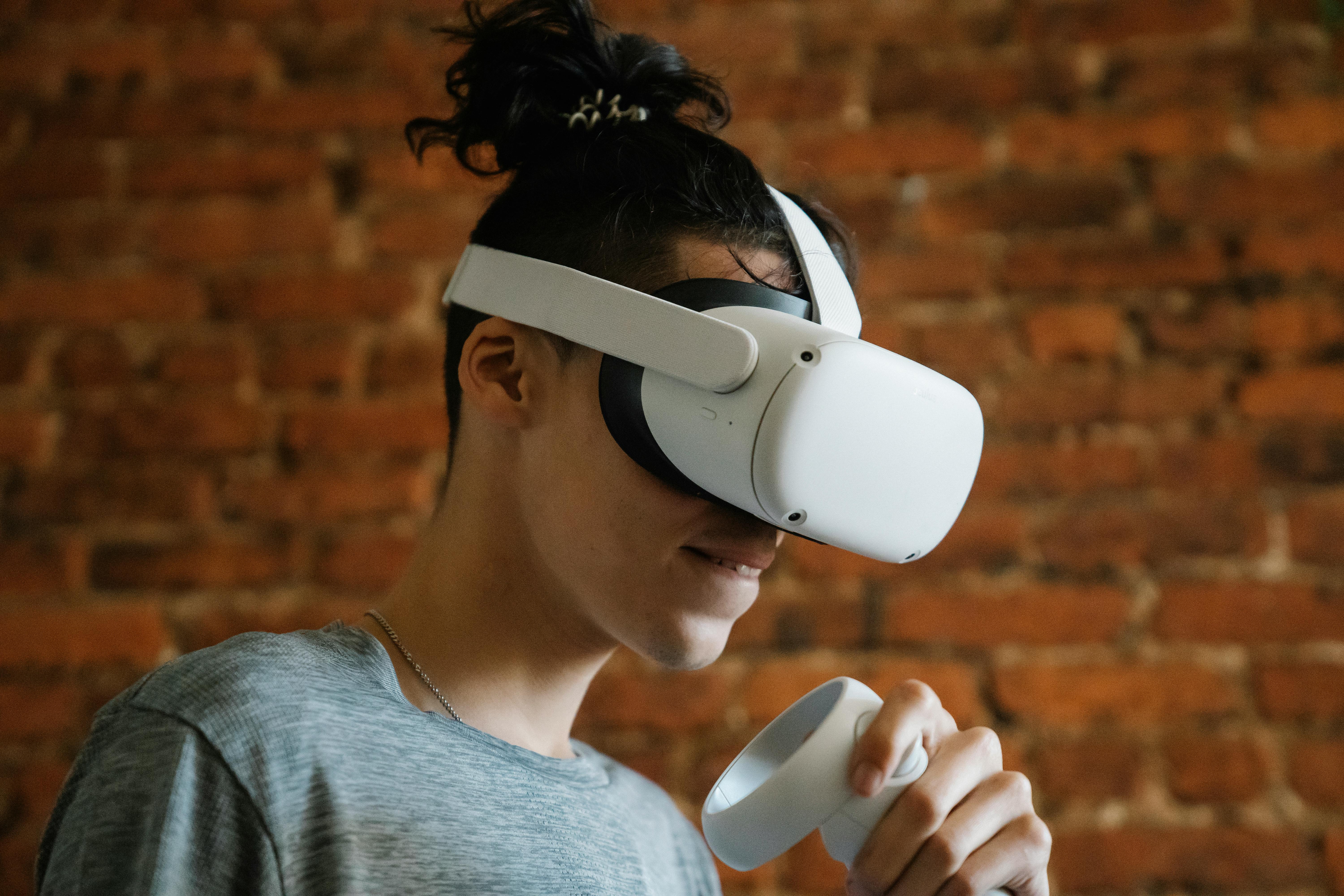 excited young man with controller and vr goggles