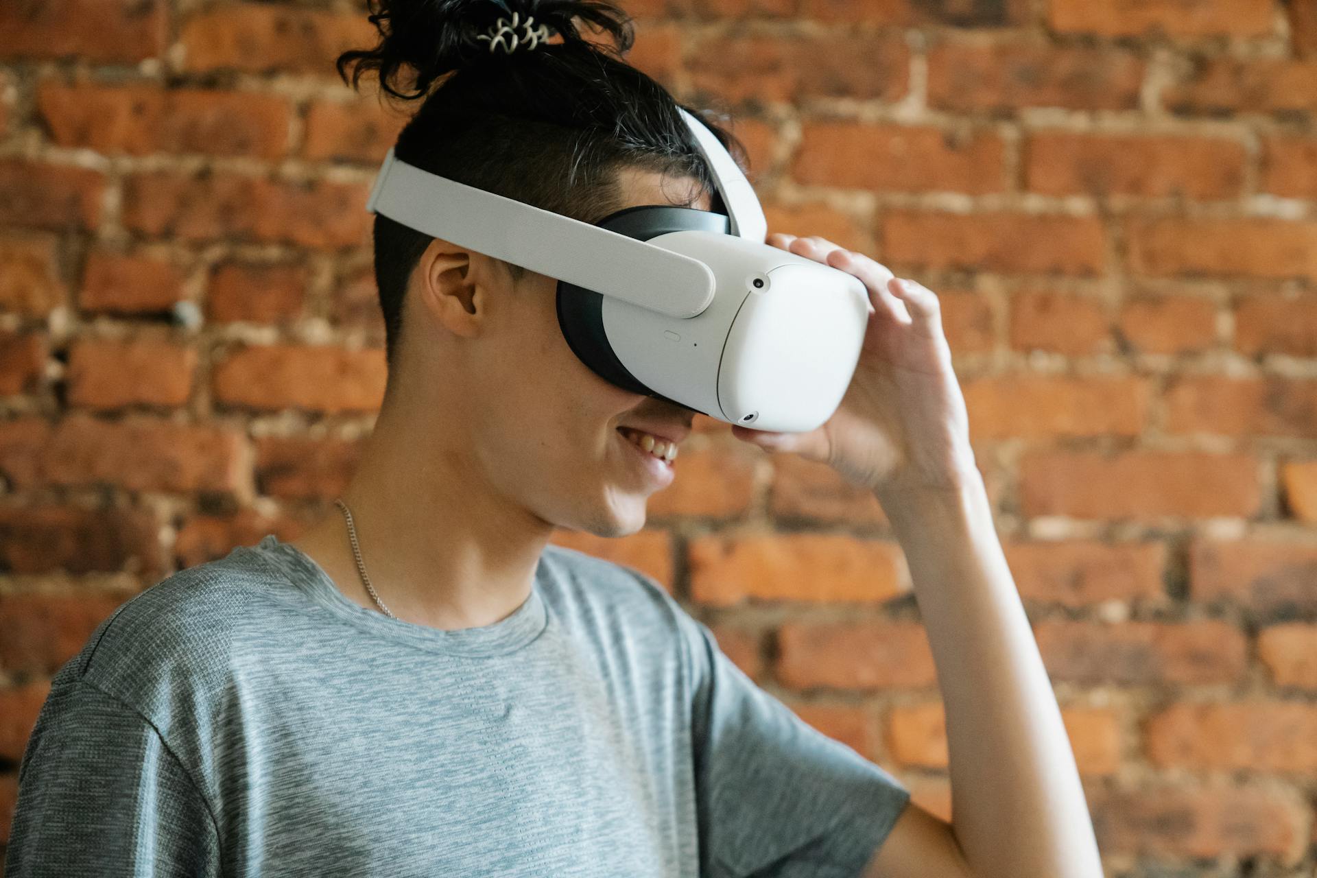 Young man putting on VR goggles