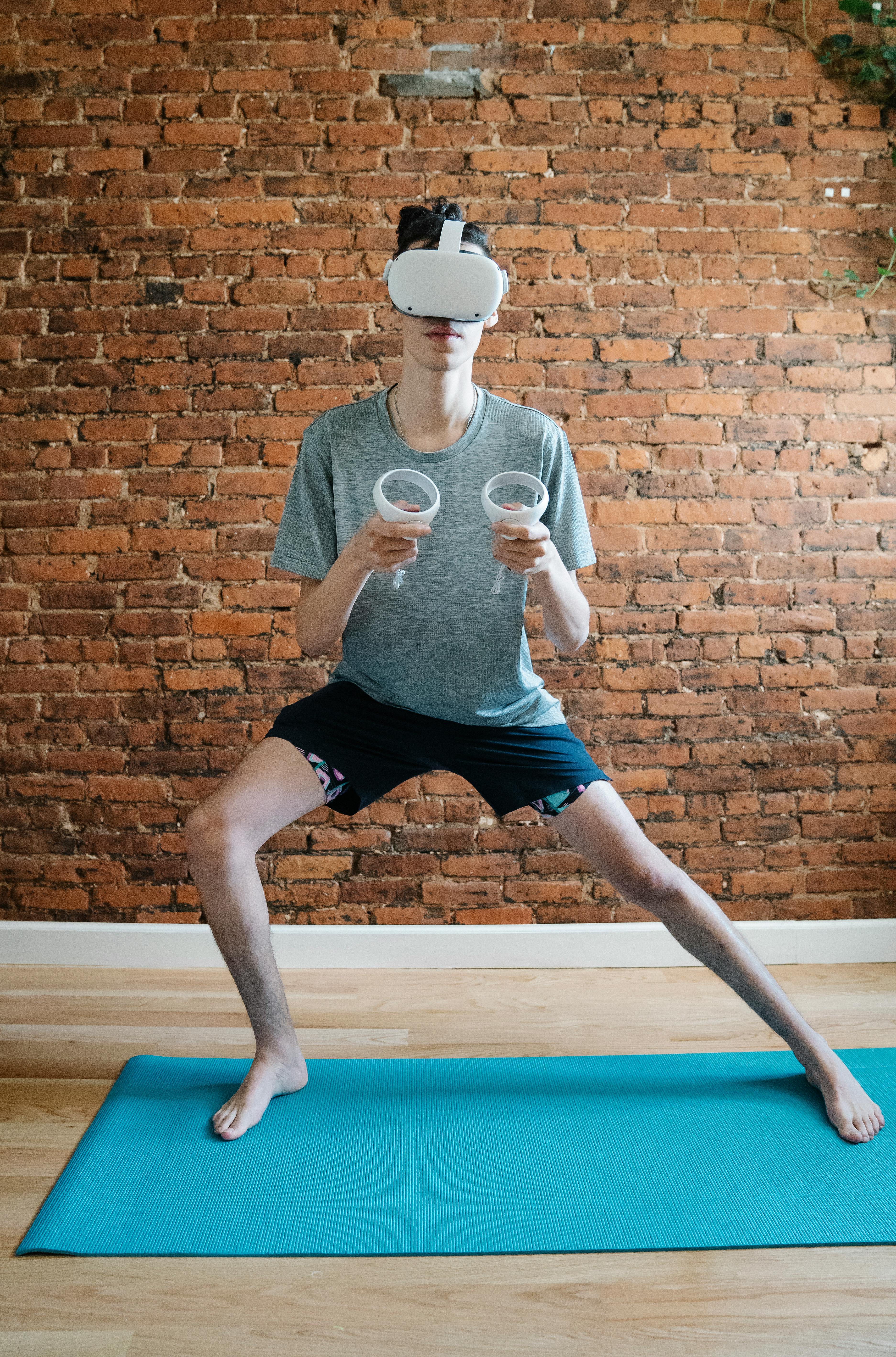 unrecognizable man practicing yoga in vr headset