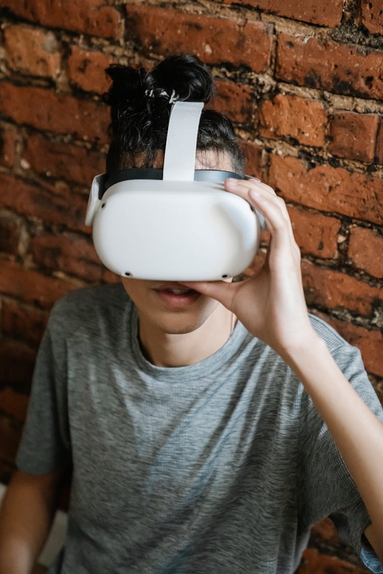 Young Man Putting On VR Headset