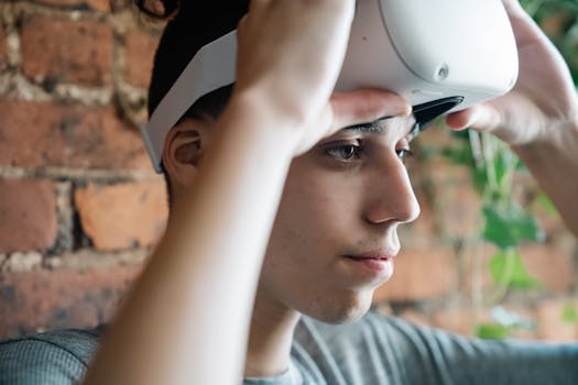 A teenager wearing a VR headset indoors against a rustic brick wall, focusing intently.