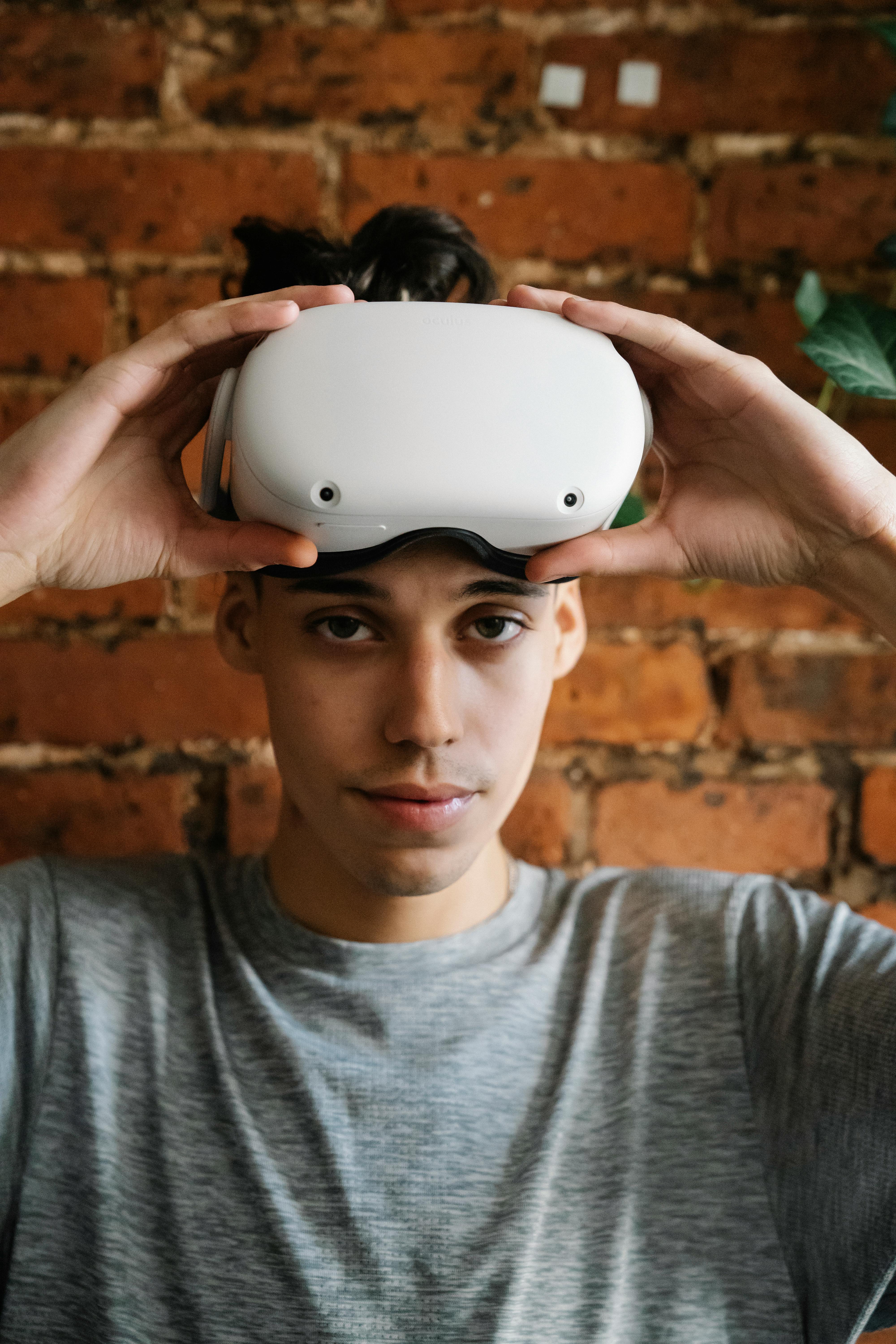 male teenager gamer raising vr goggles
