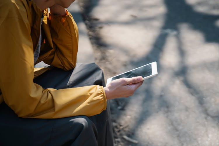 Crop Person Using Tablet In Street