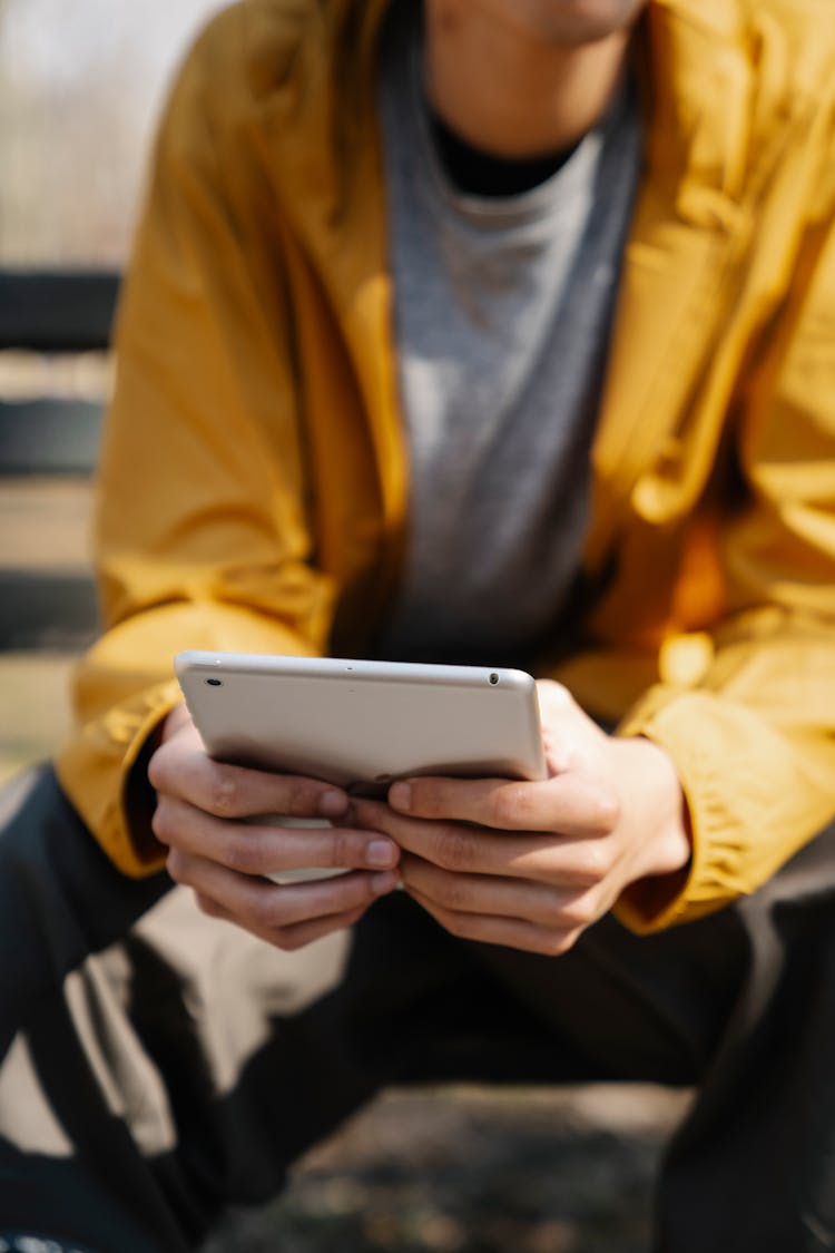 Anonymous Person With Tablet In Hands In City