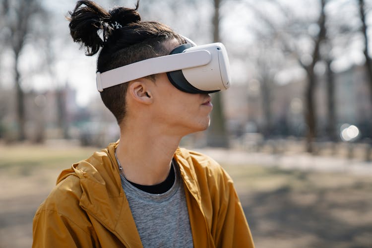 Young Man In VR Headset In Park