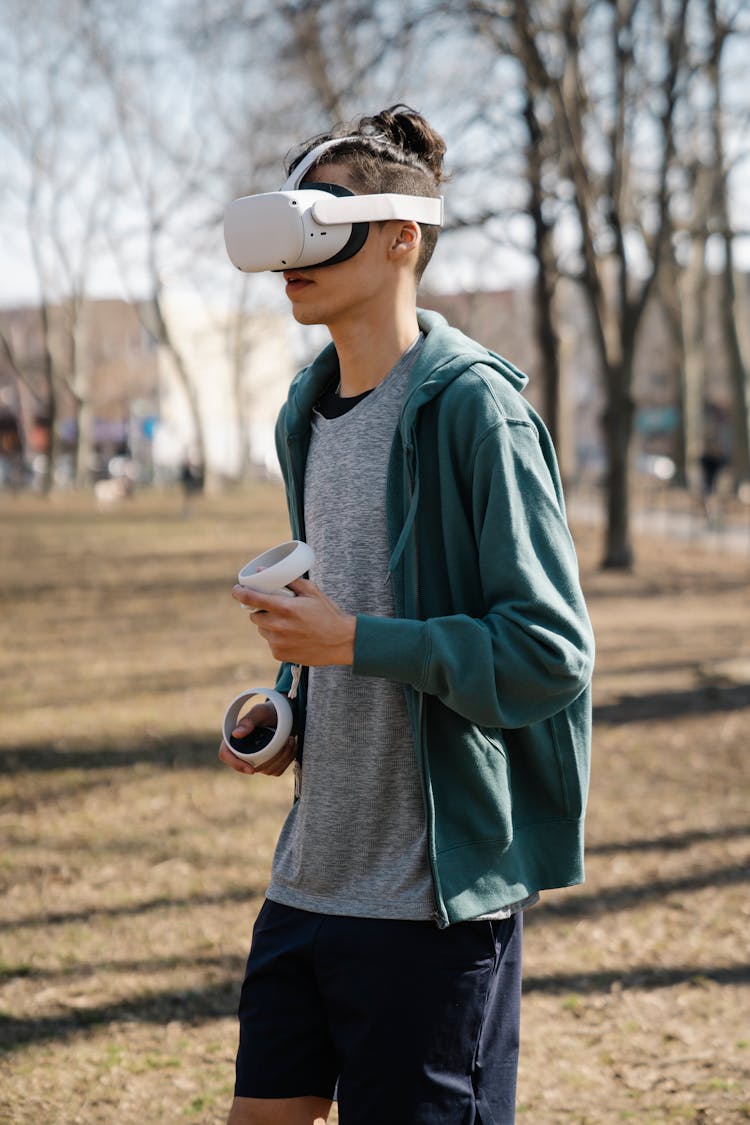 Young Man In Casual Clothes And VR Goggles