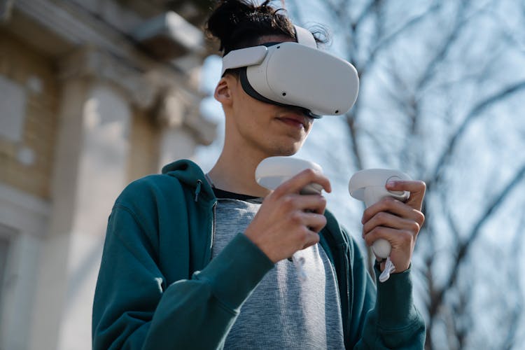 Excited Young Man In Goggles Of Virtual Reality