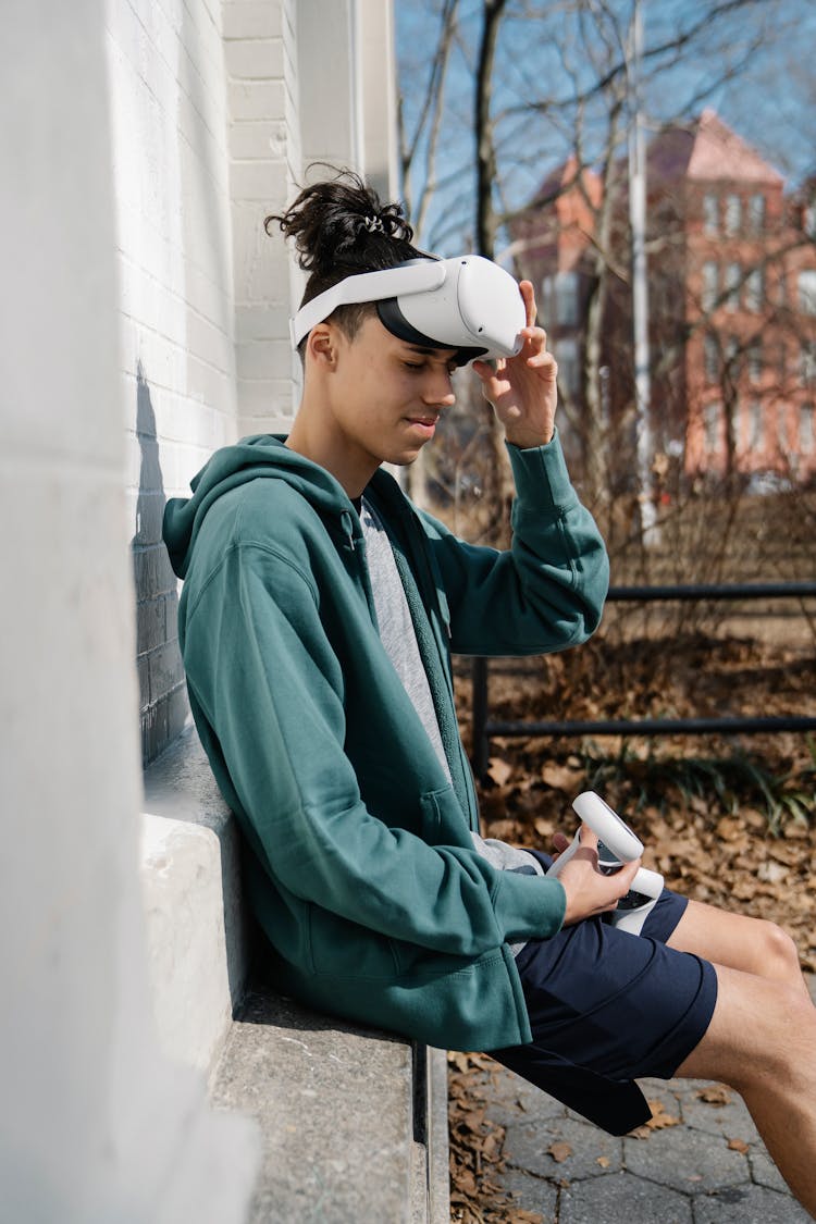 Young Man Putting On VR Goggles