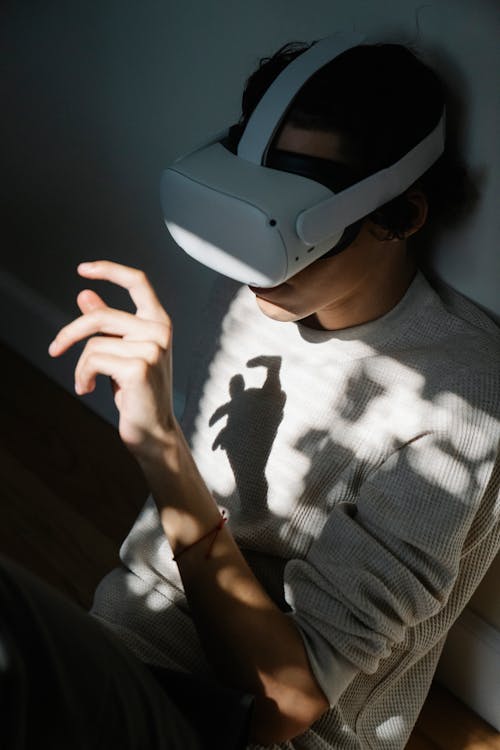 Man exploring virtual reality in headset at home in sunbeam