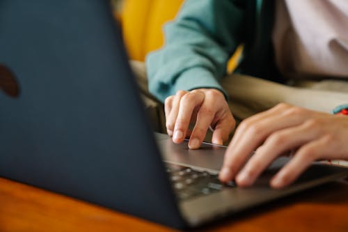 Free Crop remote worker typing on laptop in house Stock Photo