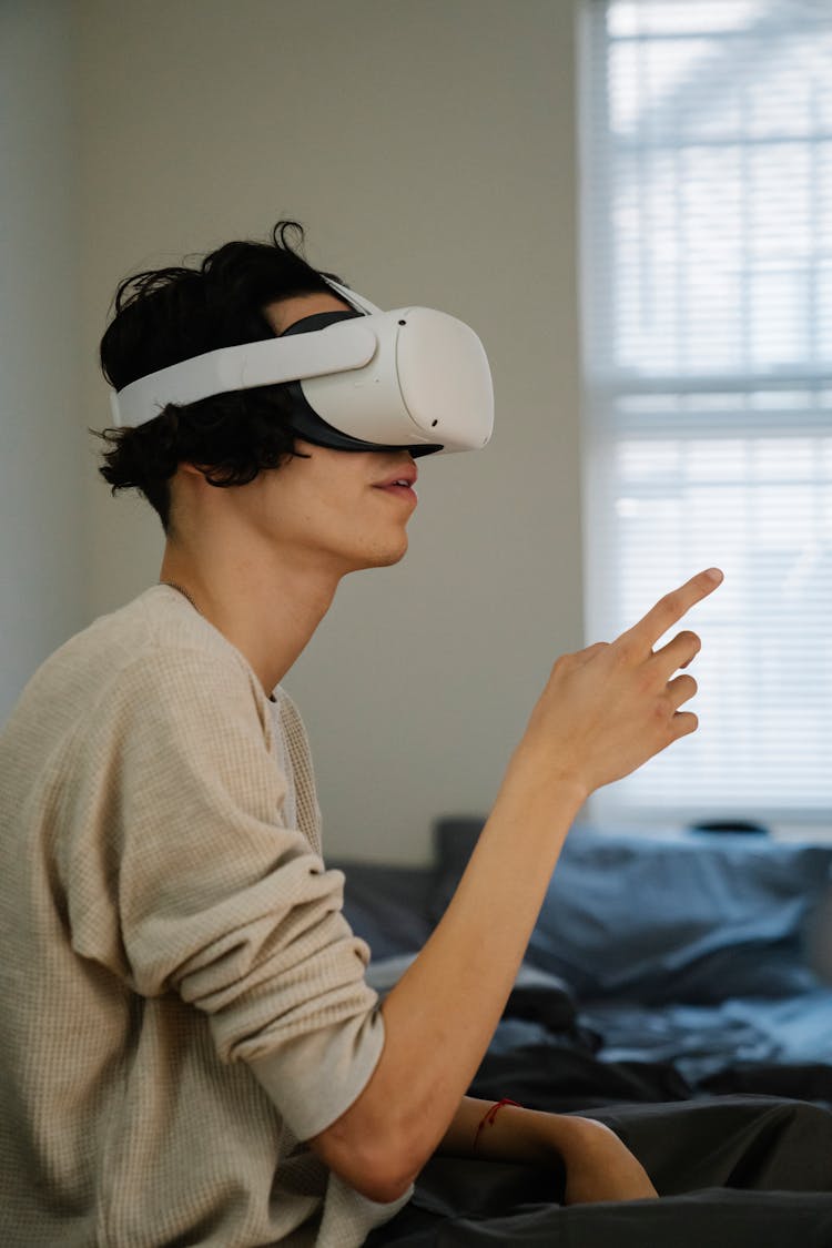 Man Exploring Virtual Reality In Goggles At Home