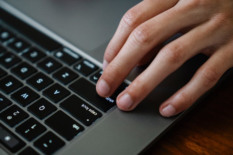 Crop Office Worker Typing On Laptop At Table