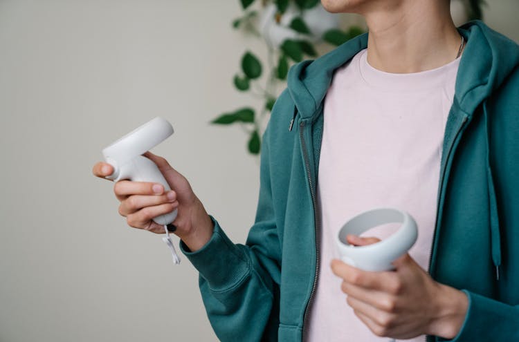 Crop Gamer With Controllers Playing Video Game At Home