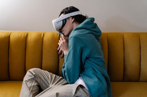 Free Man in VR headset sleeping on sofa Stock Photo