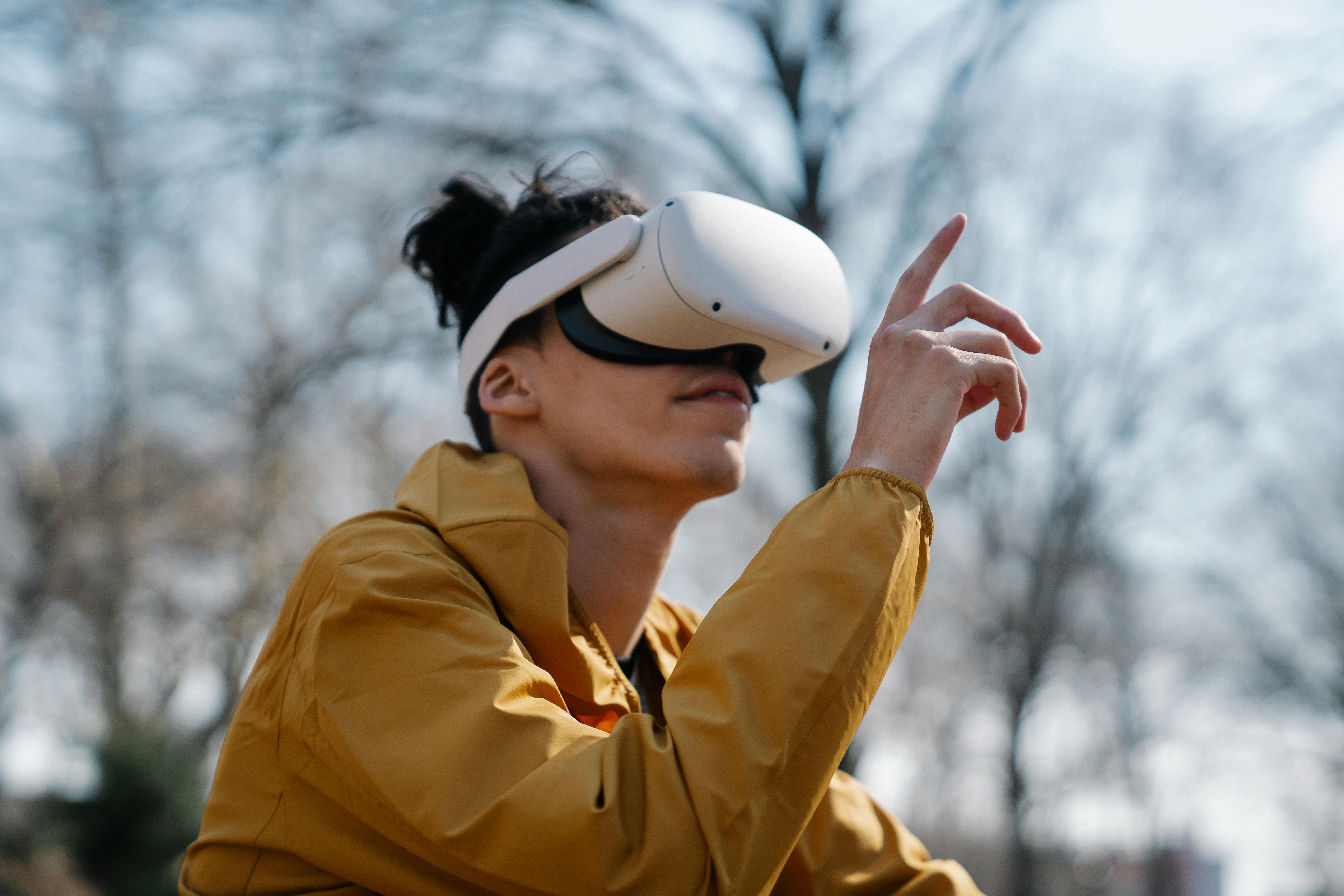 man in yellow jacket using vr headset