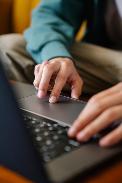 Free A Person Using a Laptop Stock Photo