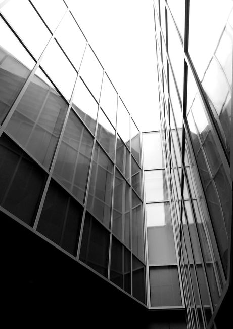 Black and white of exterior of contemporary building with glass walls in daylight
