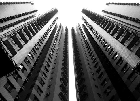 Black and white of tall contemporary buildings located in residential city district in daylight