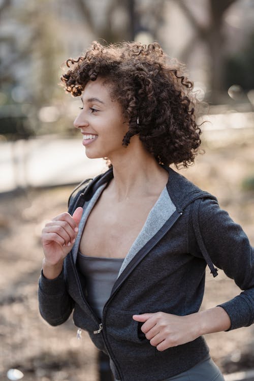Smiling black female runner with curly hairstyle