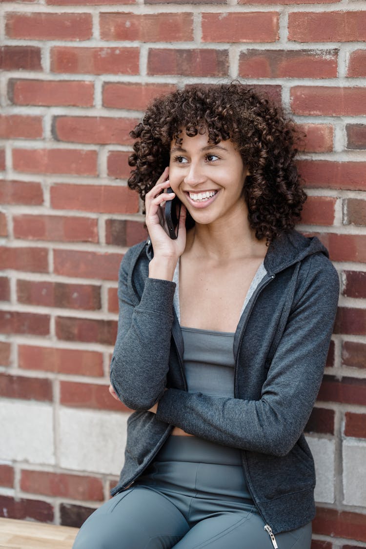 Cheerful Black Woman Speaking On Phone