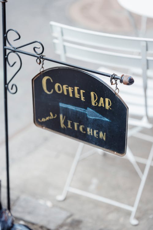Sign with Coffee Bar inscription in town