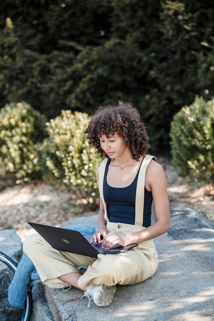 Young Woman Working On Laptop In Park