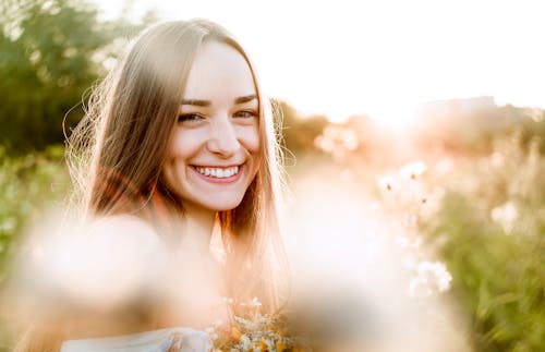 A Woman with Brown Hair Backlit by the Sunset