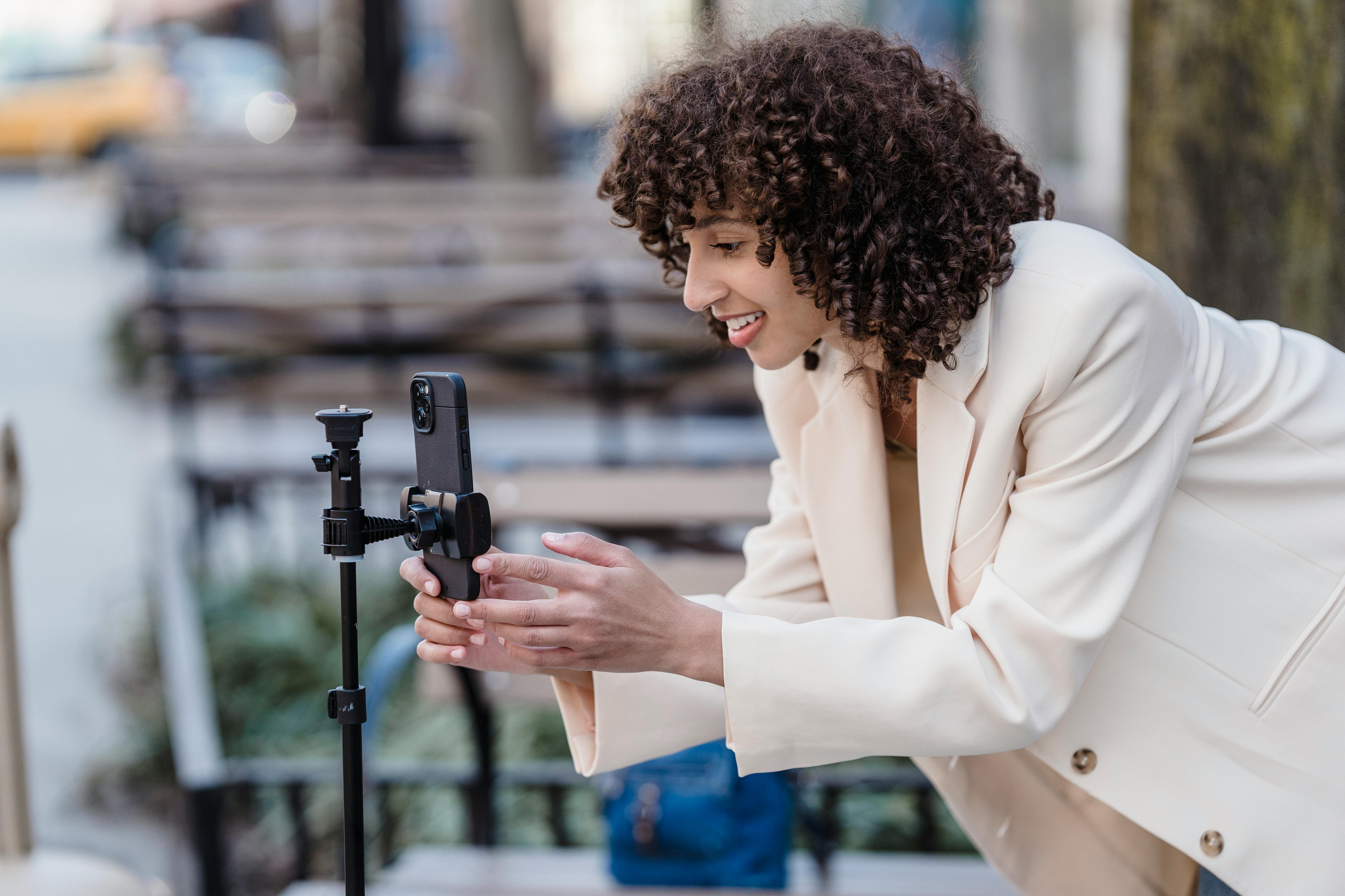 cheerful ethnic woman having video chat on smartphone in park