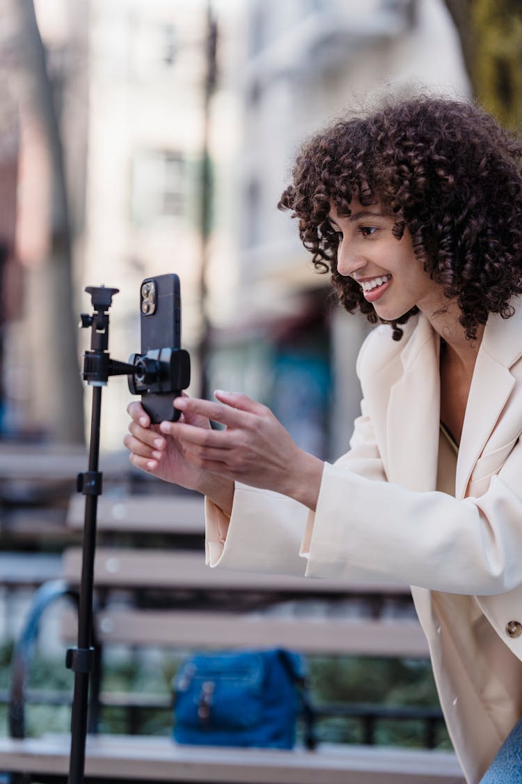 Smiling Ethnic Woman Recording Video On Smartphone