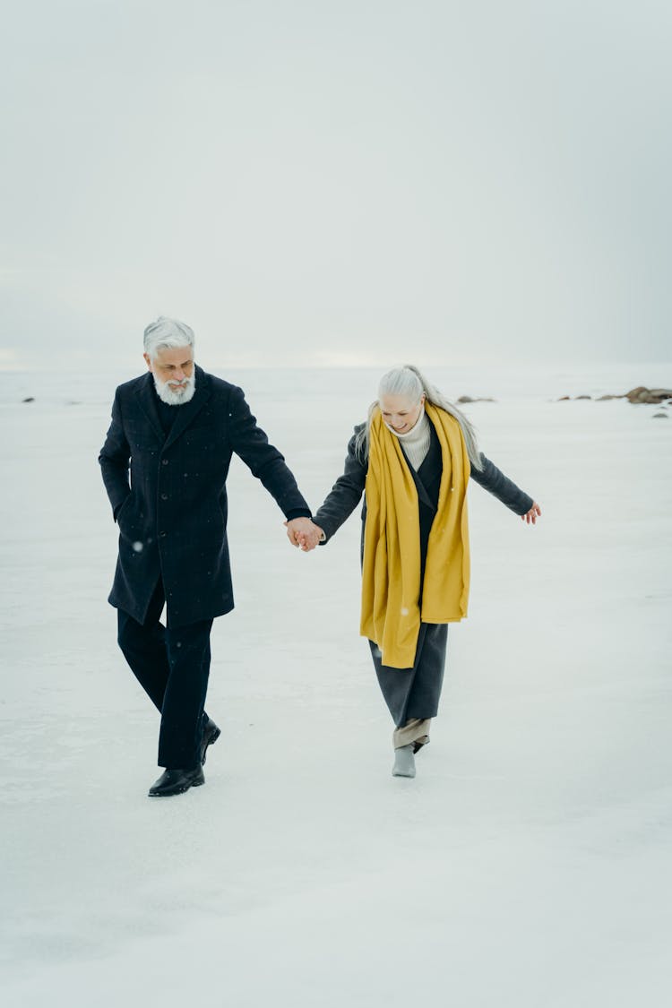 Elderly Couple Walking On Snow