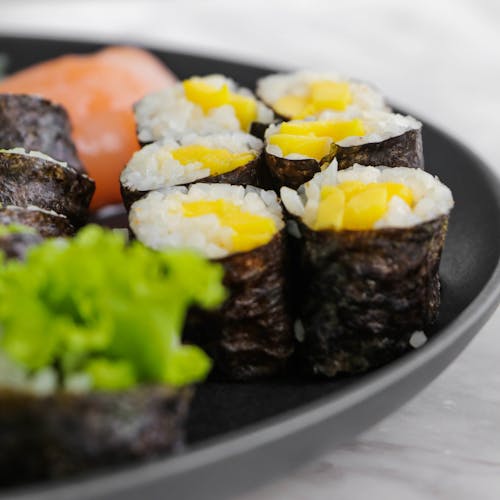 Close-Up Shot of a Delicious Sushi on a Black Plate