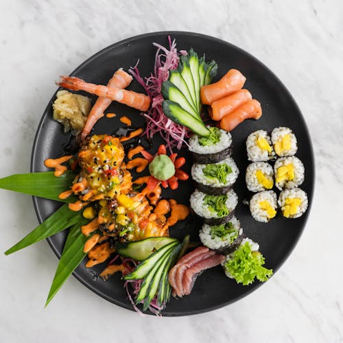 Sushi and Sashimi on a Black Plate
