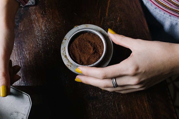 Woman Holding A Bowl Of Ground Coffee Powder 