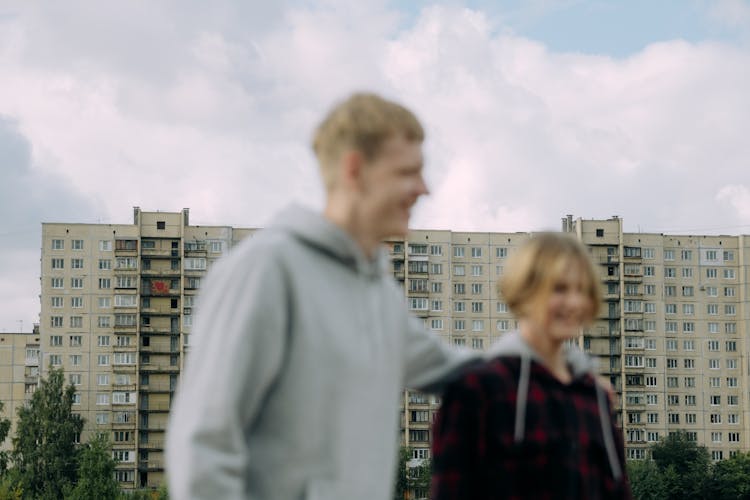 A Siblings Standing Near A Building