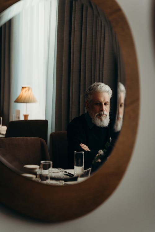 Reflection of an Elderly Man with Gray Hair