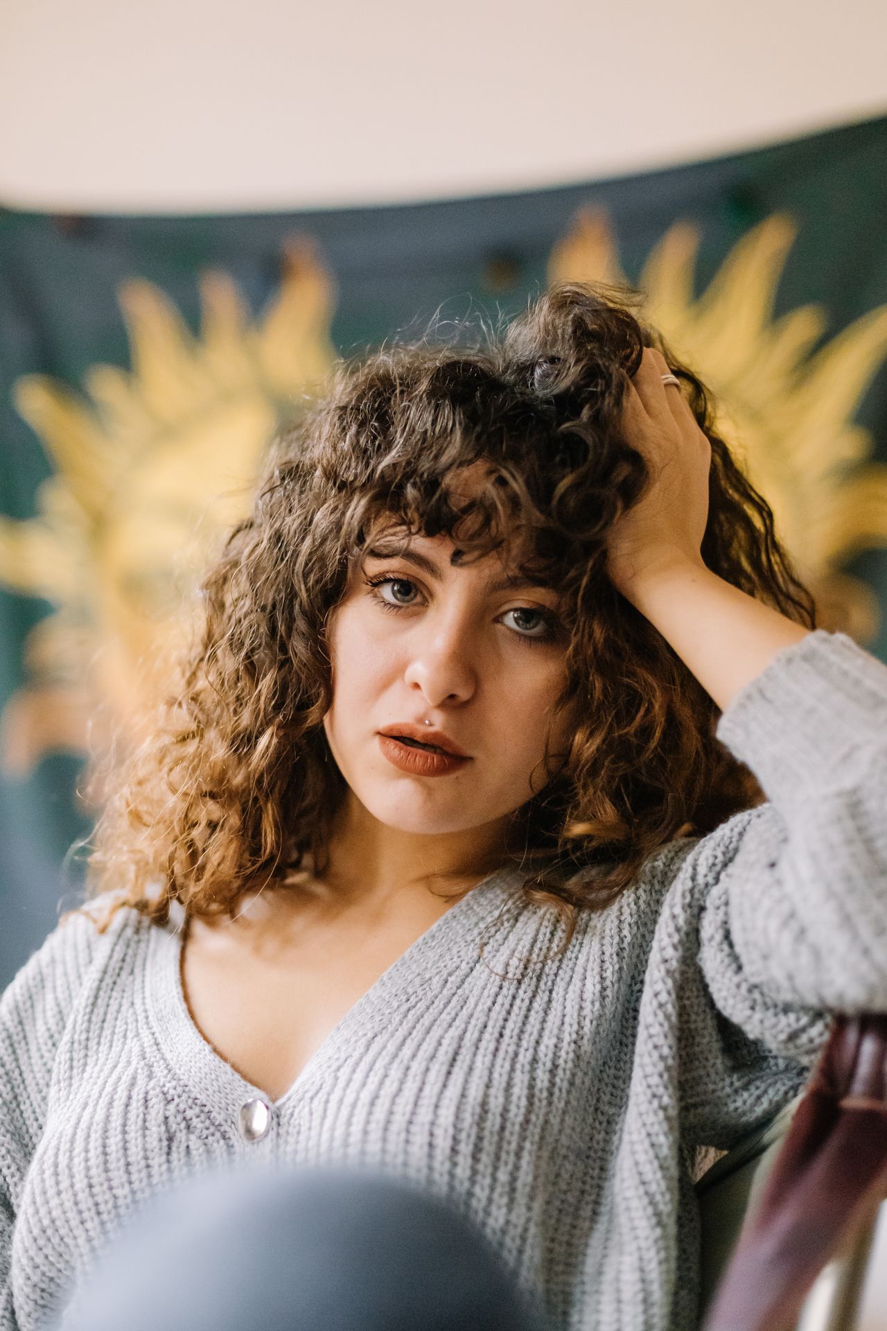 Woman with defined curly hair and a curly fringe
