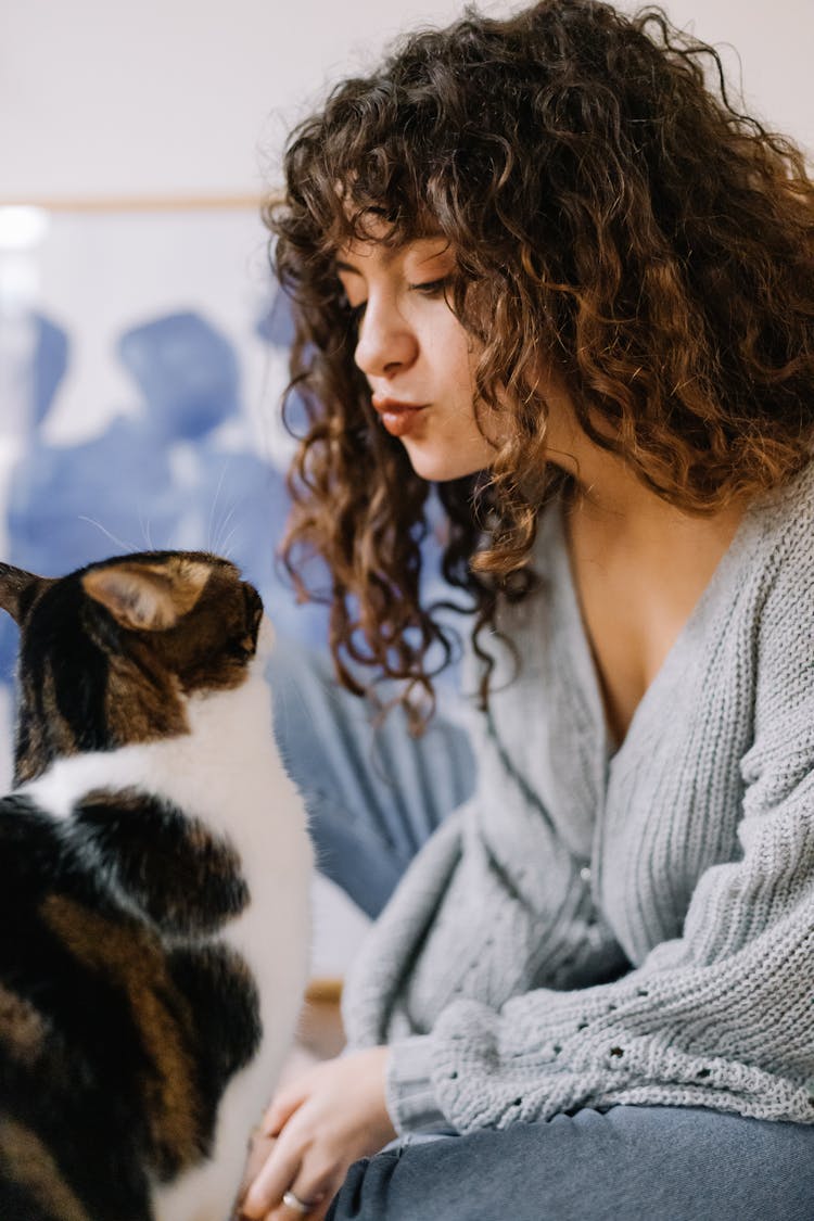 A Woman Kissing A Cat