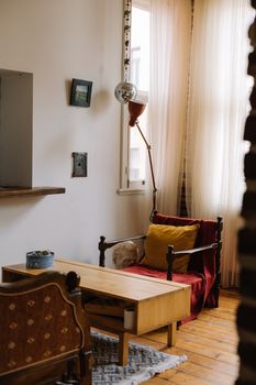 A stylish living room corner with an armchair and coffee table in Istanbul, Turkey, showcasing modern interior design.