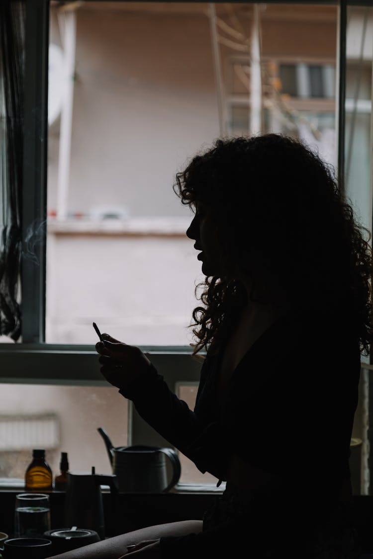 Silhouette Of A Woman Near A Window