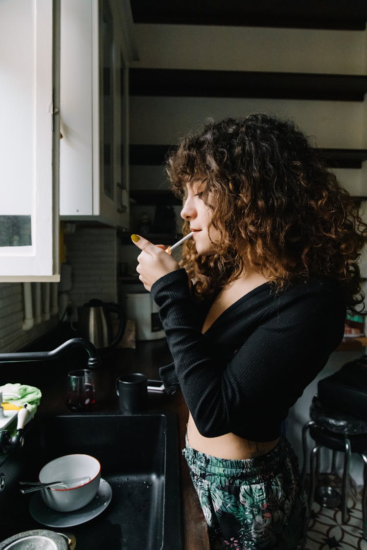 A Woman Lighting A Cigarette